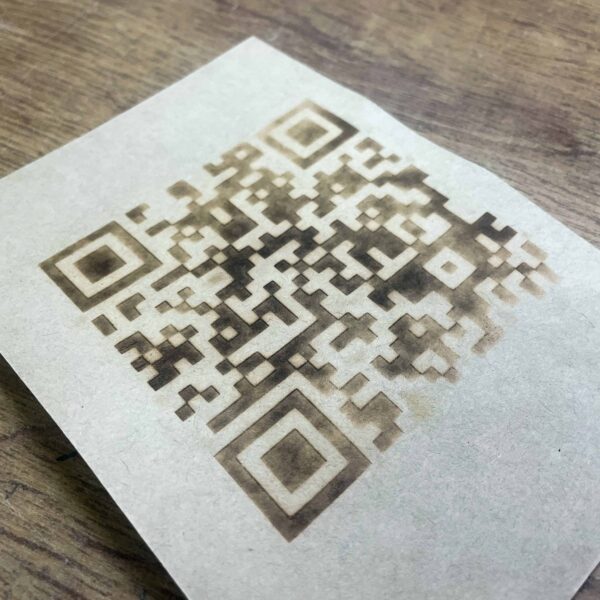 Das Foto zeigt ein QR-Code-Brandmotiv auf Kraftpapier.
